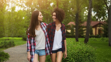 Young happy girls walking in park