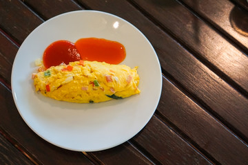 Close up breakfast Omelette's rolls with tomato and chili sauce on the table. American breakfast style.