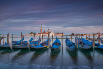 Venetian Gondolas with San Giorgio Maggiore in th ebackground during blue hour 