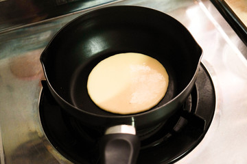 Making pancakes on frying pan , top view.