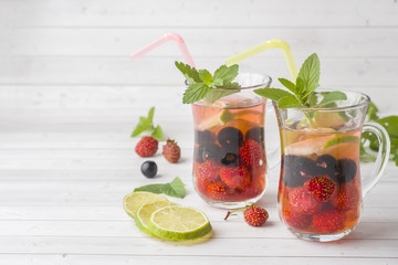 Cocktail with black currant, strawberry, mint and lime. Cooling summer drink.