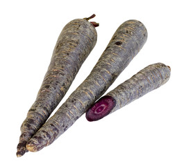 Purple carrots with one cut out isolated on white background