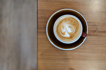 Top view latte art on wooden table, background