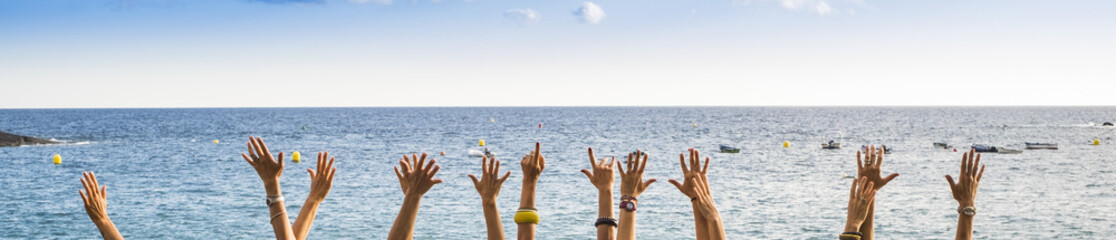 group of female hands in panoramic style with ocean in background, colors and vacation concept. happiness for group of young people in the summer time. joyful and outdoor leisure lifestyle people. 
