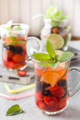 Cocktail with black currant, strawberry, mint and lime. Cooling summer drink.