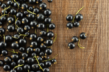 Fresh Raw Black Currant berry on brown wood