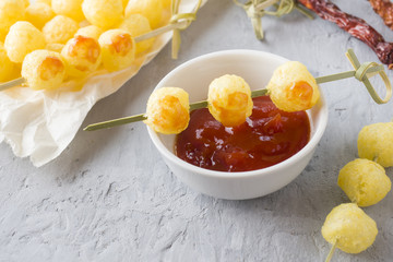 Cheese corn balls with spicy tomato sauce
