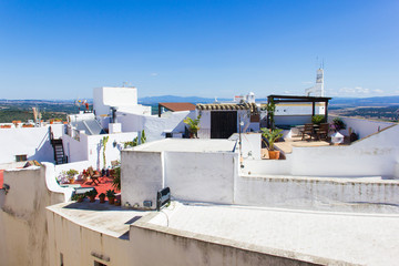 Fototapeta premium Views of roof terraces on beautiful sunny day in Vejer white town, Spain. Guided tour, summer vacation, travel destination concepts