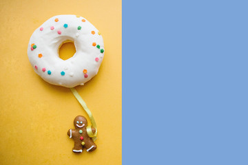 Gingerbread man holds a donut in his hand that looks like a balloon. Creative idea. Holiday...
