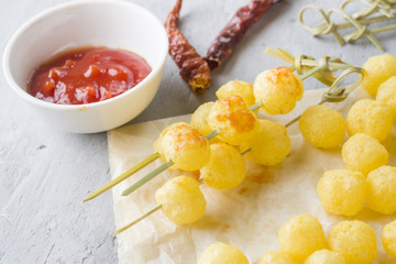 Cheese corn balls with spicy tomato sauce