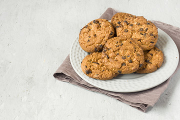 Homemade cookies with chocolate in a plate on a grey table. Chocolate chip cookie shot