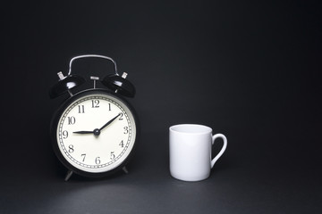 bell clock and white cup