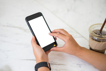 Business woman using smartphone in office. Blank screen mobile phone for graphic display montage.