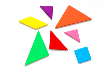 Color wood tangram puzzle in wait to build shape on white background