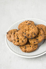 Homemade cookies with chocolate in a plate on a grey table. Chocolate chip cookie shot
