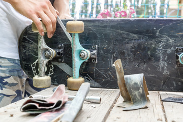 Skateboarder checks the wheel pair on the board
