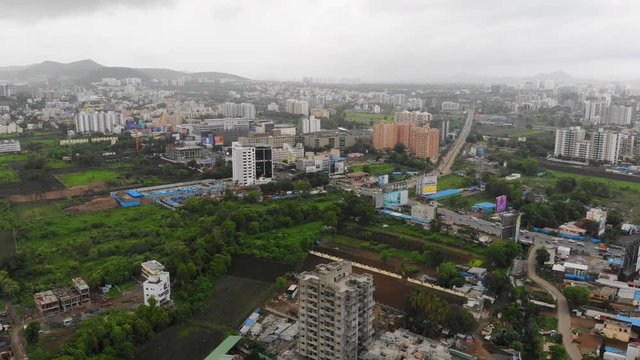 Aerial panoramic view of cityscape of modern industrial city of Pune during monsoon season - Maharashtra, landscape panorama of India, Asia from above