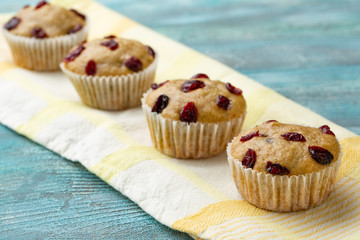 Cupcakes with cherries are located in a row.