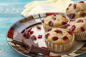 Homemade cupcakes with cherries are located on a light background. A few cupcakes are located on a plate