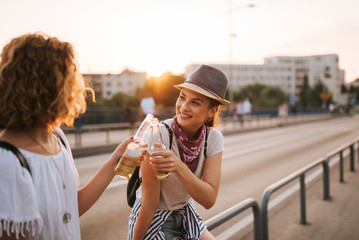 Female friends cheering in the city in the summer.