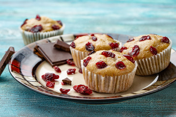 Homemade cupcakes with cherries are located on a light background. A few cupcakes are located on a plate