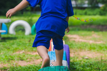 Kids running on tires in the playground