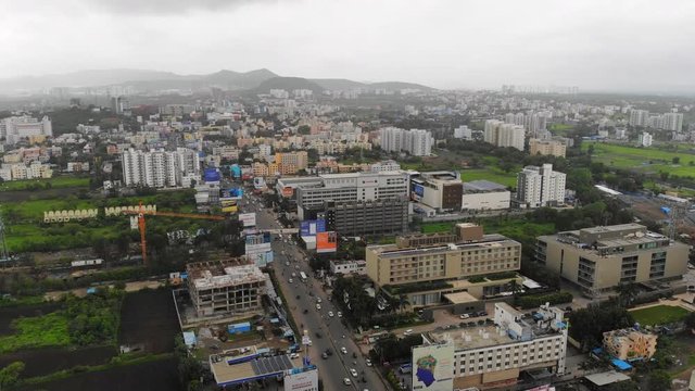 Aerial panoramic view of cityscape of modern industrial city of Pune during monsoon season - Maharashtra, landscape panorama of India, Asia from above