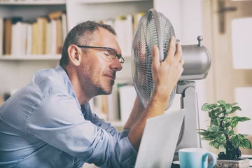 Foto op Plexiglas Man suffers from heat in the office or at home © Monika Wisniewska