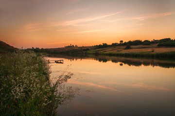 Rural landscape river in sunset sky in retro style