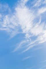 White feathery clouds on the blue sky in summer