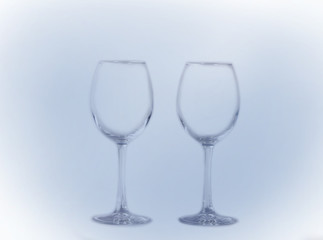 two transparent empty glasses on a long leg