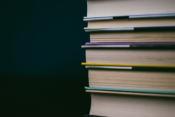 Heap of books on the cork board. Closeup of pages. Abstract concept of knowledge, education, learning, and literature.
