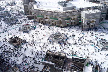 MECCA, SAUDI ARABIA - MAY 02 2018: View on central Mecca square near Masjid Al Haram mosque from balcony at restaurant on top of Clock Tower or Abraj Al Bait. Crowd of people walking, day light