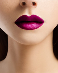 Sexual full lips and long neck. Darkly pink lipstick and gentle skin of the woman. The mouth is...