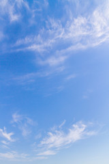 White feathery clouds on the blue sky in summer