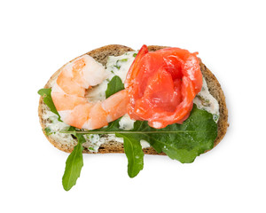 Small sandwich with shrimp, salmon and arugula isolated on white