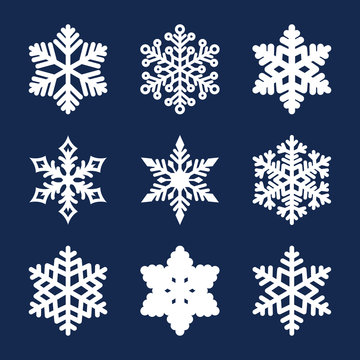Vector set of 9 white snowflakes isolated on dark background. New year and Christmas design elements. Christmas snowflakes icon set