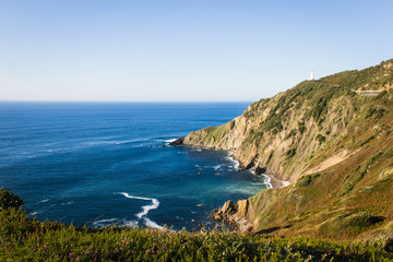 Fototapeta na wymiar Great views of Cape Villano and Gorliz lighthouse on coast of Biscay by Cantabrian Sea, north Spain. Natural landscape, hiking adventure concepts
