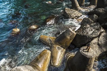 Fototapeta premium Concrete buoys on the sea rocky coast
