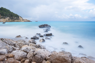 Fototapeta na wymiar Long exposure image of a rocky beach before storm