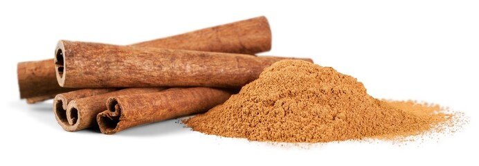 Cinnamon sticks and powder on white background