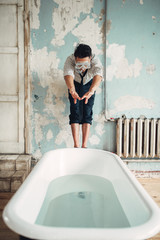 Businessman in flippers dives into the bathtub