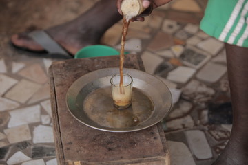 african everyday life detail - attaya preparation outdoors in Africa, with silver tray and glasses with beverage tea