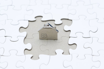 concept site or home area, key chain shape home in the middle of the puzzle