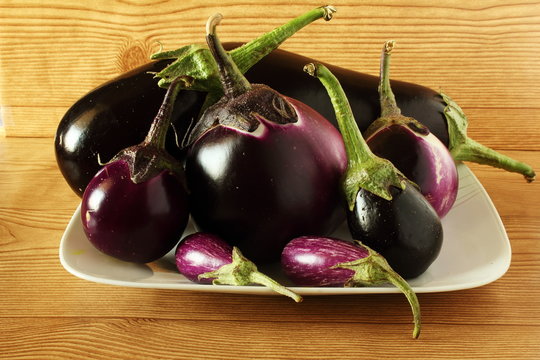 fresh eggplant or aubergine bringal varieties in wooden background