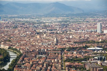 View of the city of Turin from Superga Church. Mole Antonelliana tower, skyscraper San Paolo and the river.