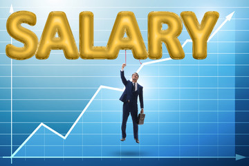 Fototapeta premium Businessman flying in salary concept