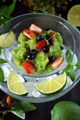 Green granita with matcha tea, lime and mint topped with fresh berries