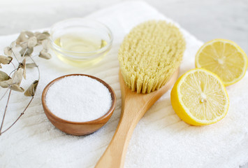 Fototapeta na wymiar Natural Ingredients for Homemade Body Sea Salt Scrub Lemon Olive Oil White Towel Beauty Concept Skincare Organic Wooden Body Massage Brush Aroma Spa Therapy