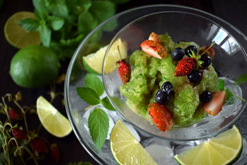 Green granita with matcha tea, lime and mint topped with fresh berries